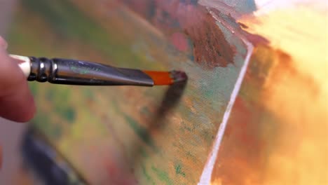 macro shot of painting on canvas with brown oil paint on painting of desert scape