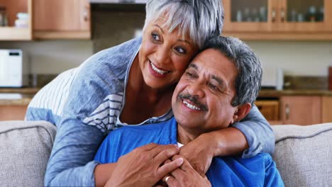 Senior-couple-embracing-each-other-in-living-room-4k