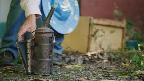 beekeeper prepares a smoke machine for work in the apiary 4k video