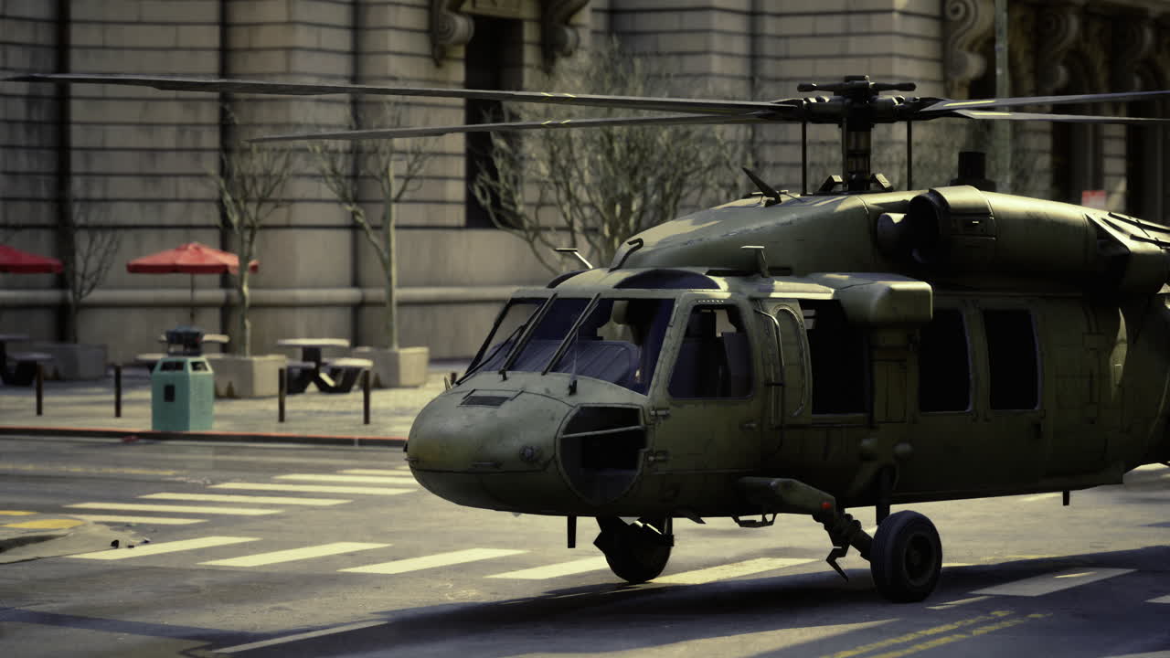 Military helicopter landing on urban street during daytime hours