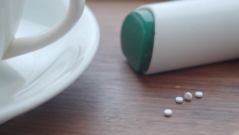 sugar substitute tablets and coffee cup on a tray