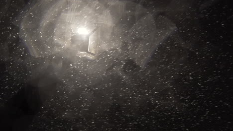 heavy snow falling and blowing under a street light