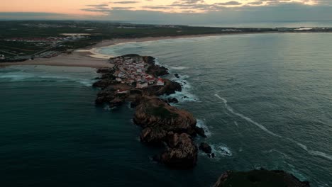 drone shot around baleal island near peniche at sunset, oeste region, portugal