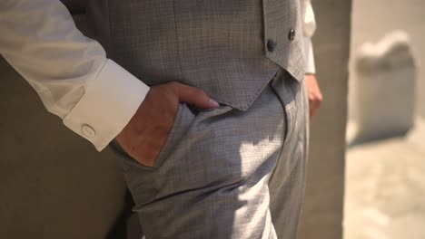 a man keeps his hands in his pocket