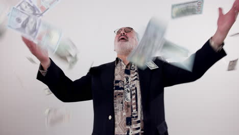 successful businessman throwing money in the air