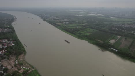 Aerial-view-of-the-Red-River-flowing-through-Hanoi,-Vietnam,-capturing-the-essence-of-natural-beauty-and-urban-harmony