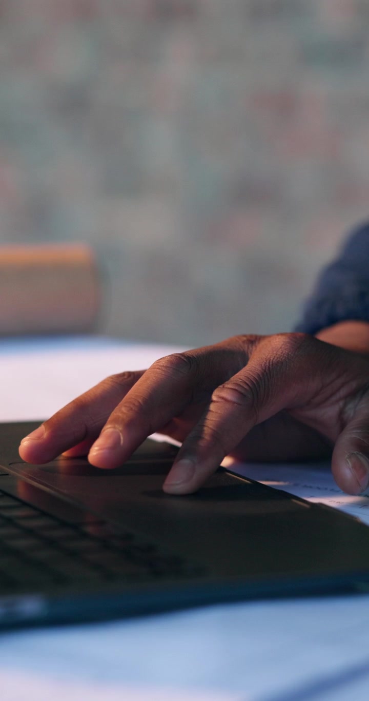Close-up of a Person Using a Laptop Trackpad