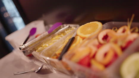 close up of colorful fruit and lime for cocktail drink garnish at bar, 4k slow motion