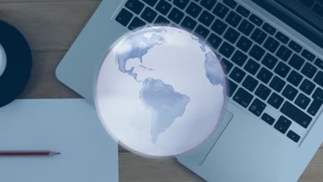 Animation-of-globe-with-network-of-connections-over-laptop