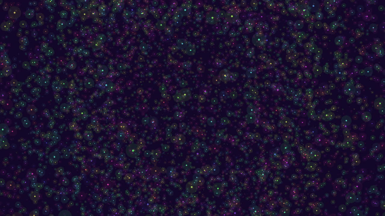 Colorful dots scatter on dark background