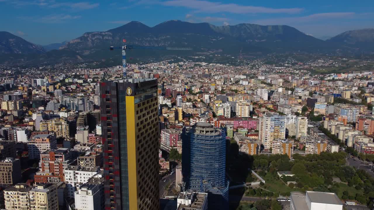 Aerial view of Tirana cityscape with skyscraper and mountains - Tirana, Albania
