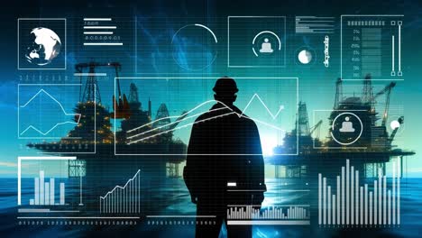 worker reviews data offshore. a worker silhouetted by an offshore oil platform analyzes data in the early morning light.