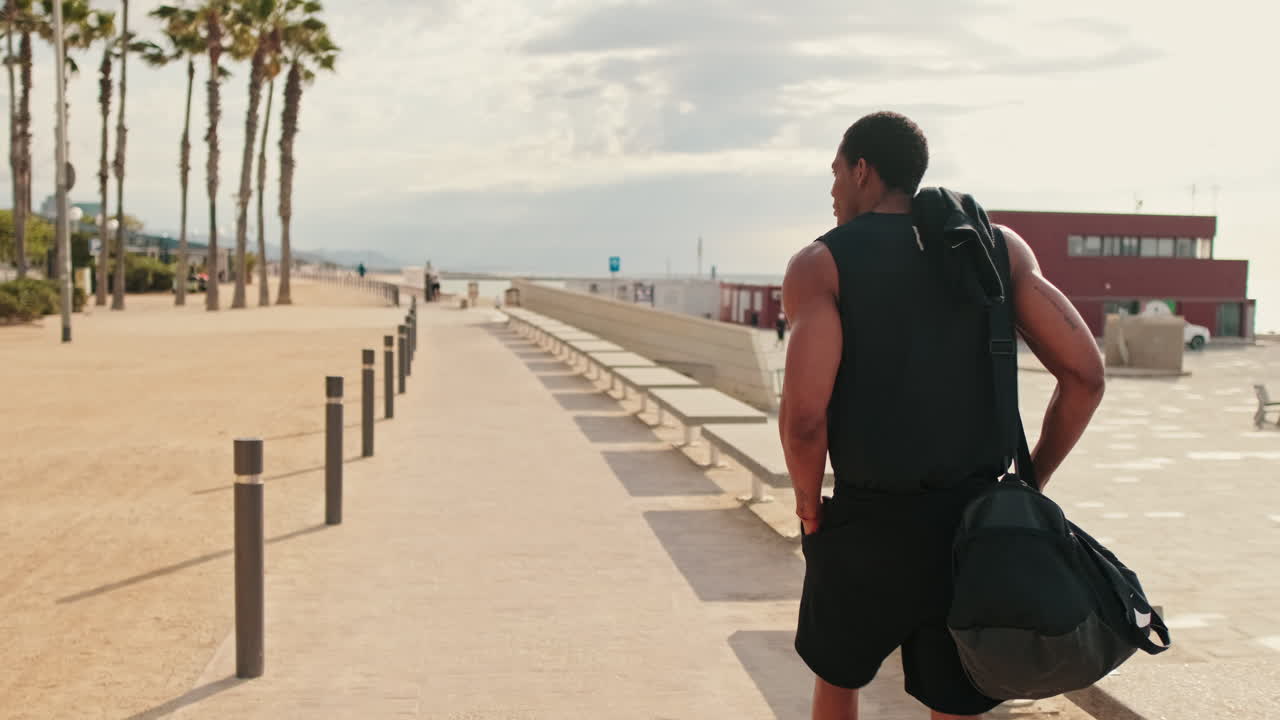 Man Walking to Workout on Beach Promenade