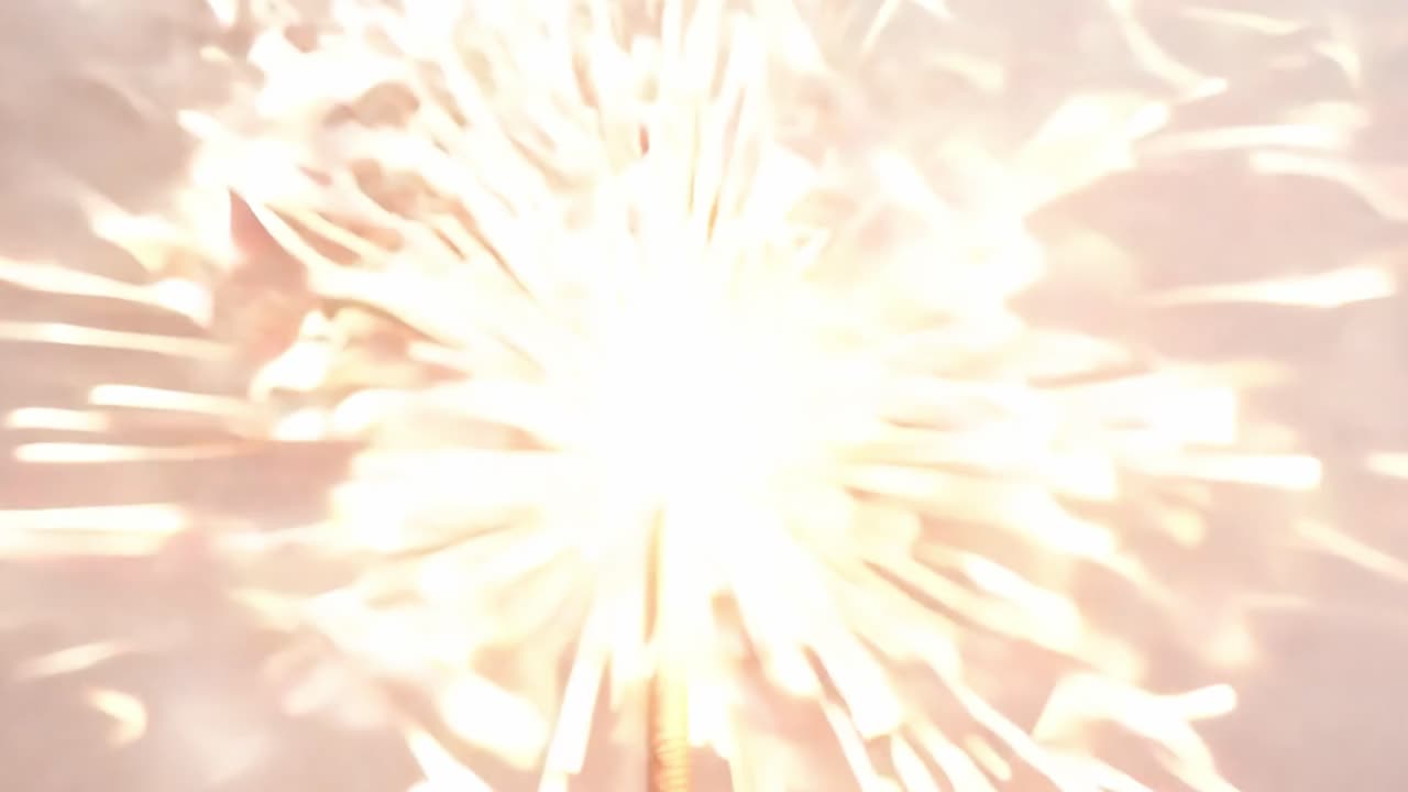 Bengal light burning with bright sparks against a white background creates a festive and celebratory atmosphere