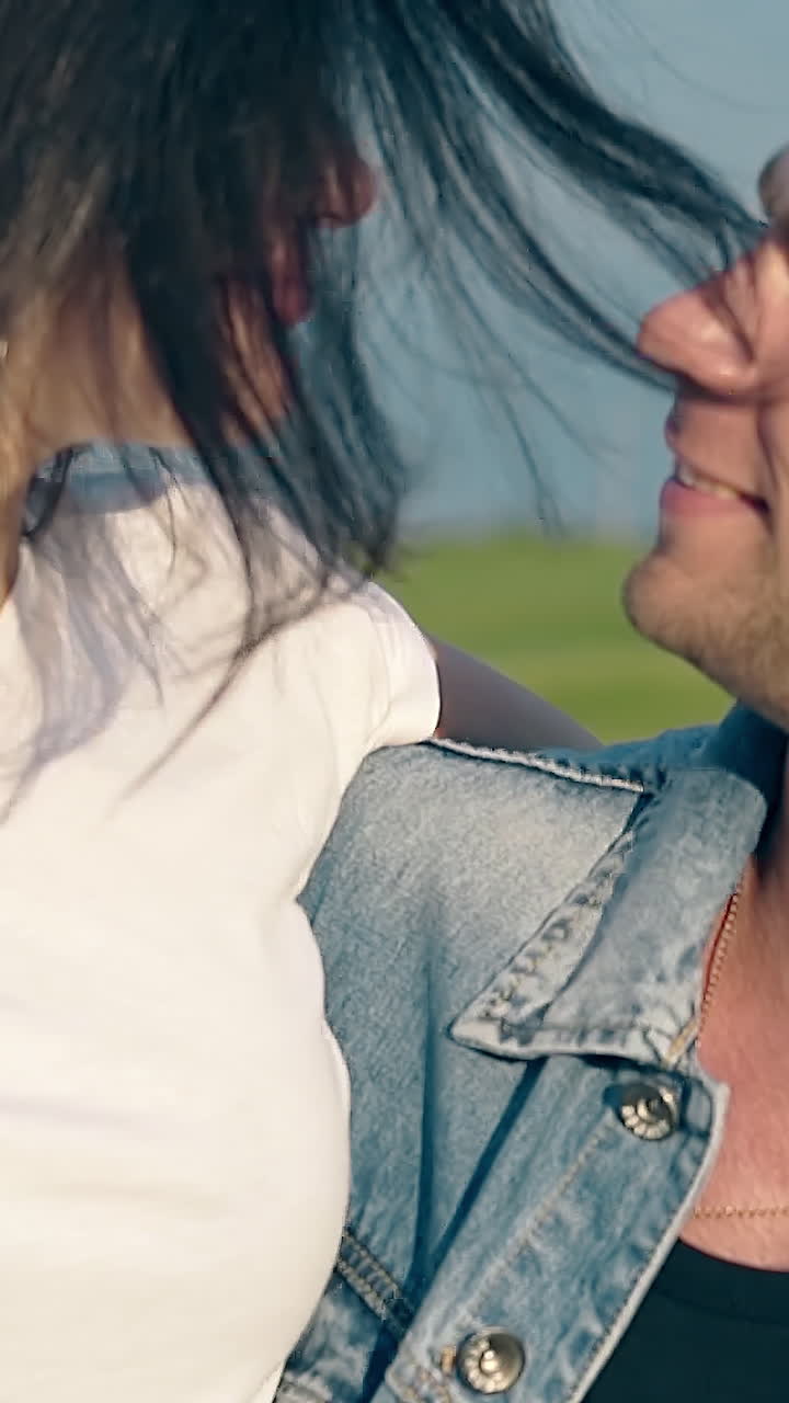 close view young brunette woman with wristwatch and earrings lifted by handsome man arm looks into eyes slow motion