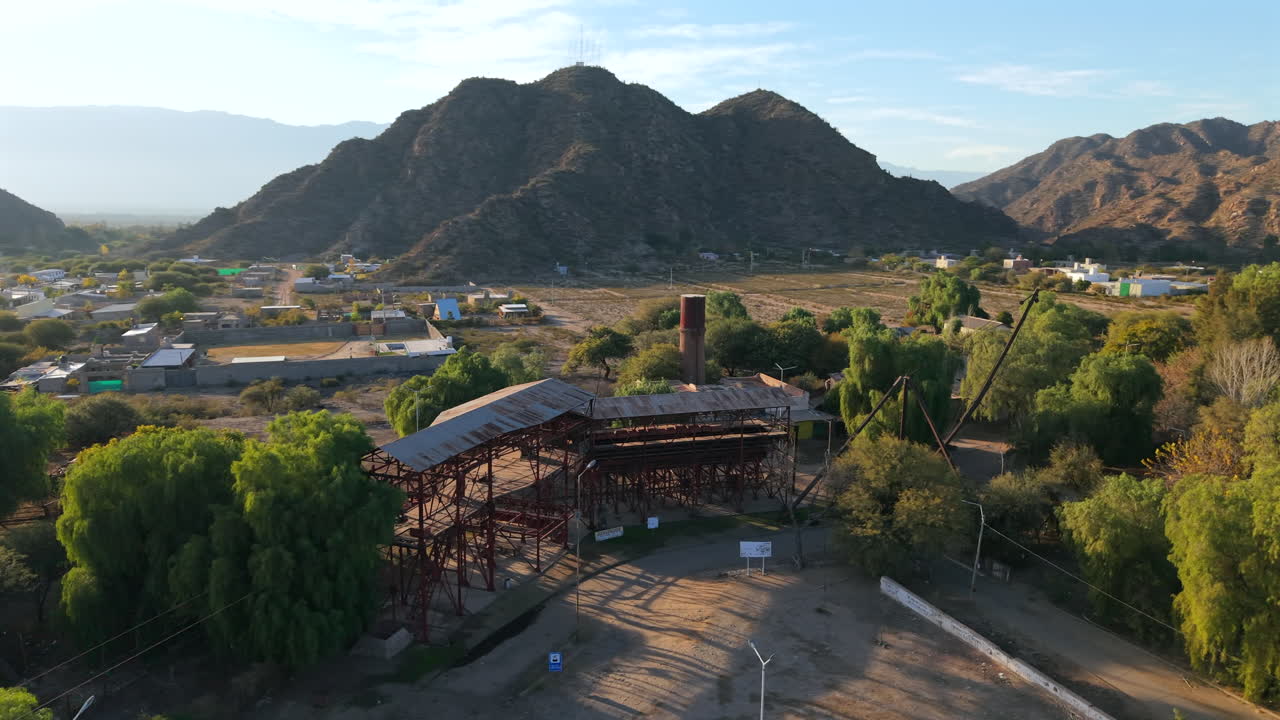 Historic mining machinery and metal structures of Estación 1 Cable Carril with mountain backdrop, Chilecito, La Rioja, Argentina
