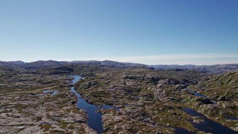 Aerial-shot,-panning-across-the-mossy,-rocky-landscape-of-Rogaland-in-Norway