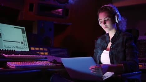 Female-sound-engineer-using-a-laptop