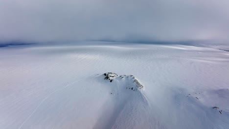 Aerial-landscape-view-of-Myrdalsjokull-glacier-covered-in-snow-in-Iceland,-on-a-cloudy-evening