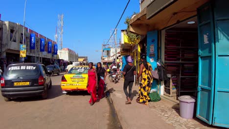 pov street walking on busy serekunda market, gambia