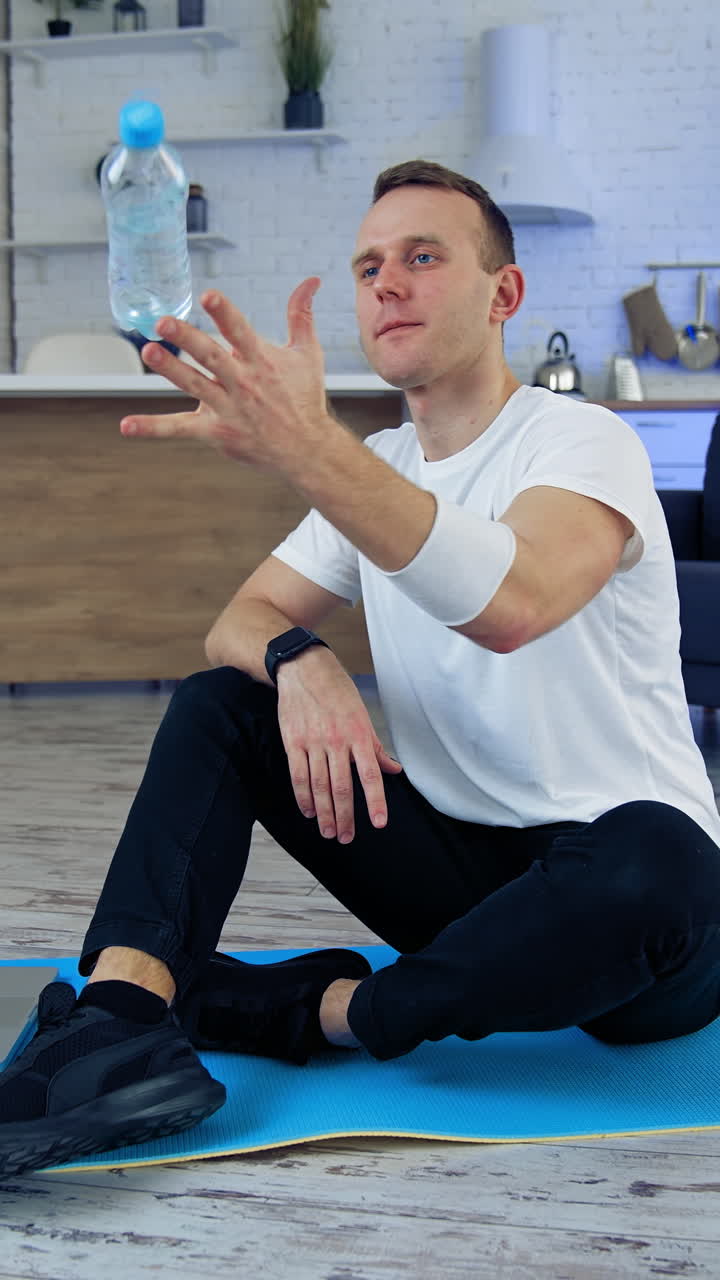 Man after exercise at home. Male sportsman resting after online fitness at home