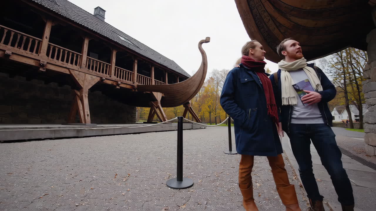 Couple Exploring a Viking Ship Museum in Autumn