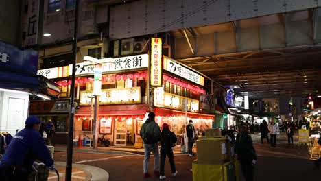 pedestrians and vendors at a lively night market