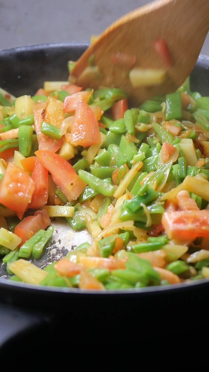 Stirring Fresh Mixed Vegetables in a Frying Pan