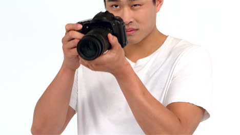 asian man taking picture with professional camera