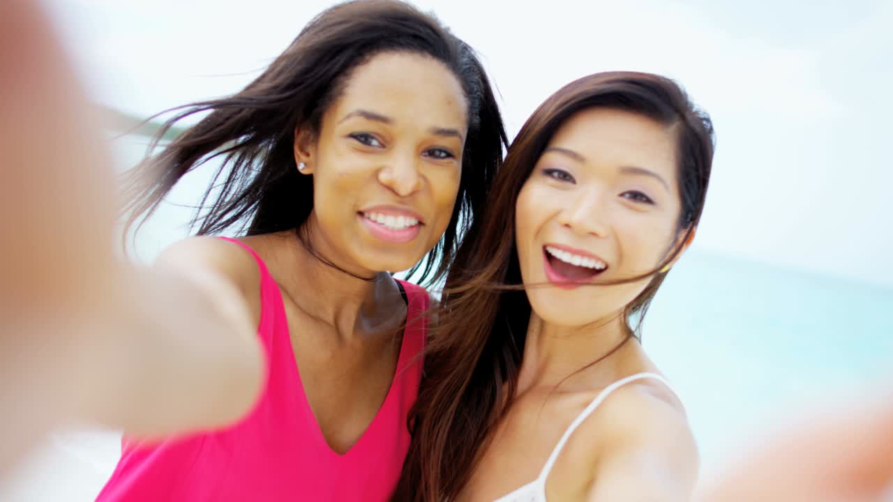 바다의 모래 위에 있는 다민족 여자친구의 초상화