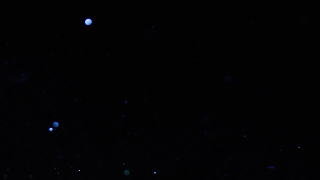 partículas de bokeh abstractas en el fondo oscuro