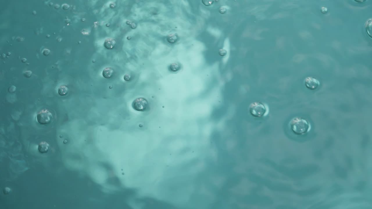 Close up view of water bubbles forming natural patterns on a calm outdoor water surface