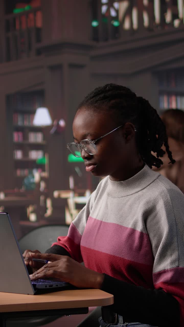 Vertical video african american student consulting academic research collection at library