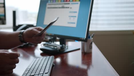 close up of two male hands exchanging a stack of cash over an office desk