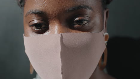 portrait of young african woman in protective mask