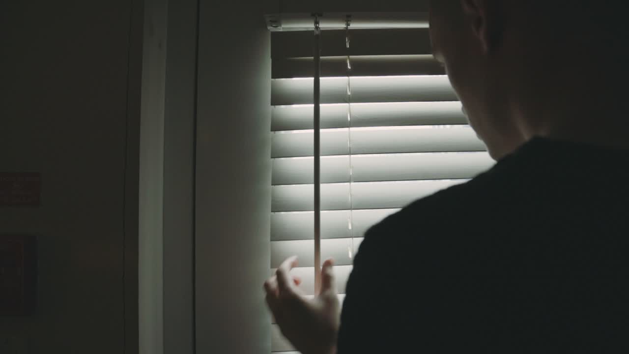 Lonely Man Closing The Window Blinds In The Morning - Closeup Shot