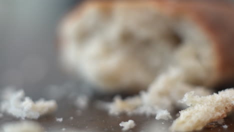 macro push in motion to bring a piece of leftover bread, half eaten in focus