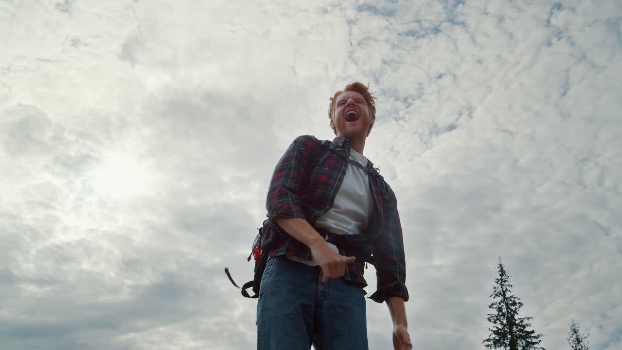 tío feliz celebrando la victoria al aire libre. turista masculino mostrando el gesto del sí
