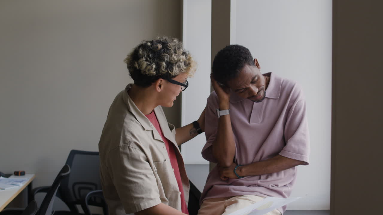 Two men engaging in a lively and humorous conversation in an office setting