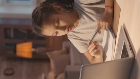 girl doing homework at a table