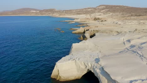 celestial landscape of sarakiniko, moonscape volcanic rhyolitic rock with amazing shapes, greek touristic place drone shot