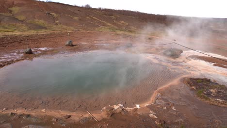 geyser valley in the southwest of iceland. the famous tourist attraction geysir. geothermal zone haukadalur. strokkur geyser on the slopes of laugarfjall hill.