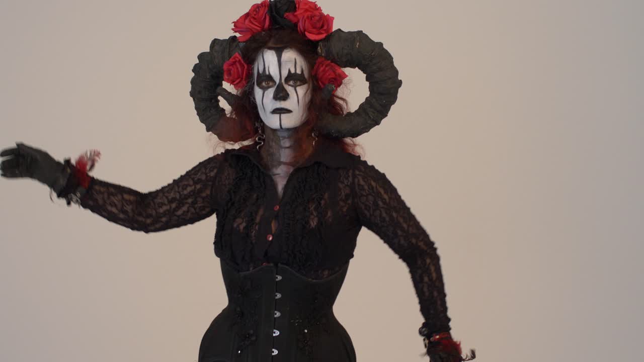 Woman in a Devil Costume with Horns and Roses