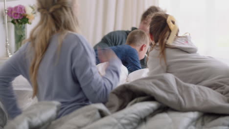 happy-family-with-children-jumping-on-bed-playing-with-mother-and-father-having-fun-on-weekend-morning-excited-little-kids-enjoying-game-with-parents-at-home-4k-footage