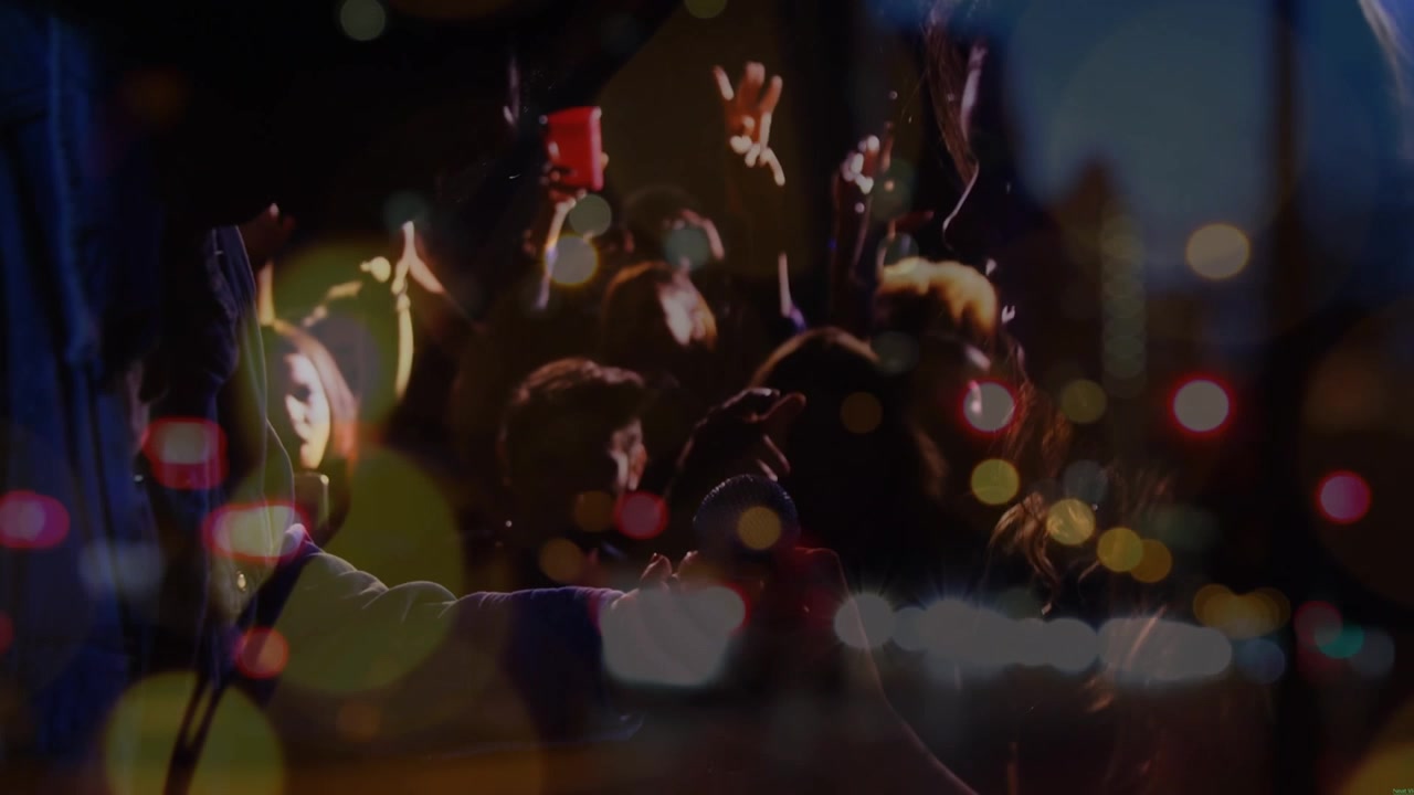 Animation on blurred night road traffic over people having fun on concert