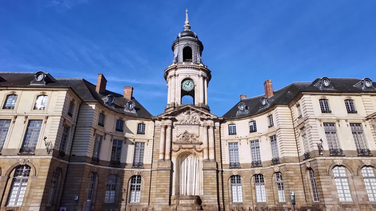 Fixed ground-level shot of Rennes City Hall and clock tower under clear blue sky