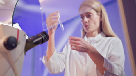 scientists observing through microscopes in laboratory setting