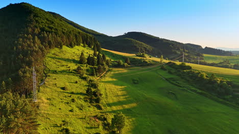 lush green hills under a clear sky. rolling green hills stretch as far as the eye can see, illuminated by the warm afternoon sun in a serene landscape