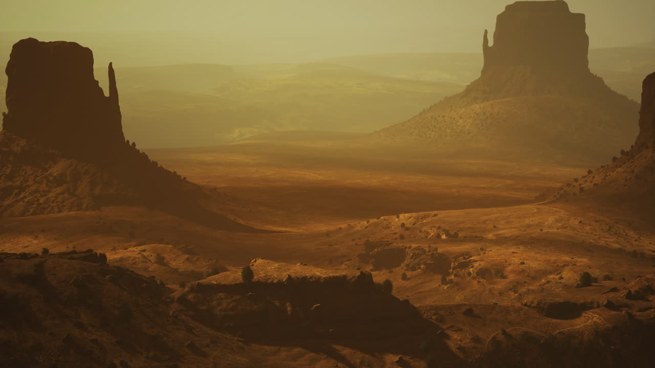 Desert landscape showcases majestic rock formations at sunset
