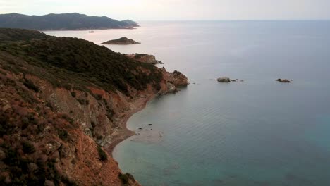sardaignan shore and sea diving view from a drone by sunset